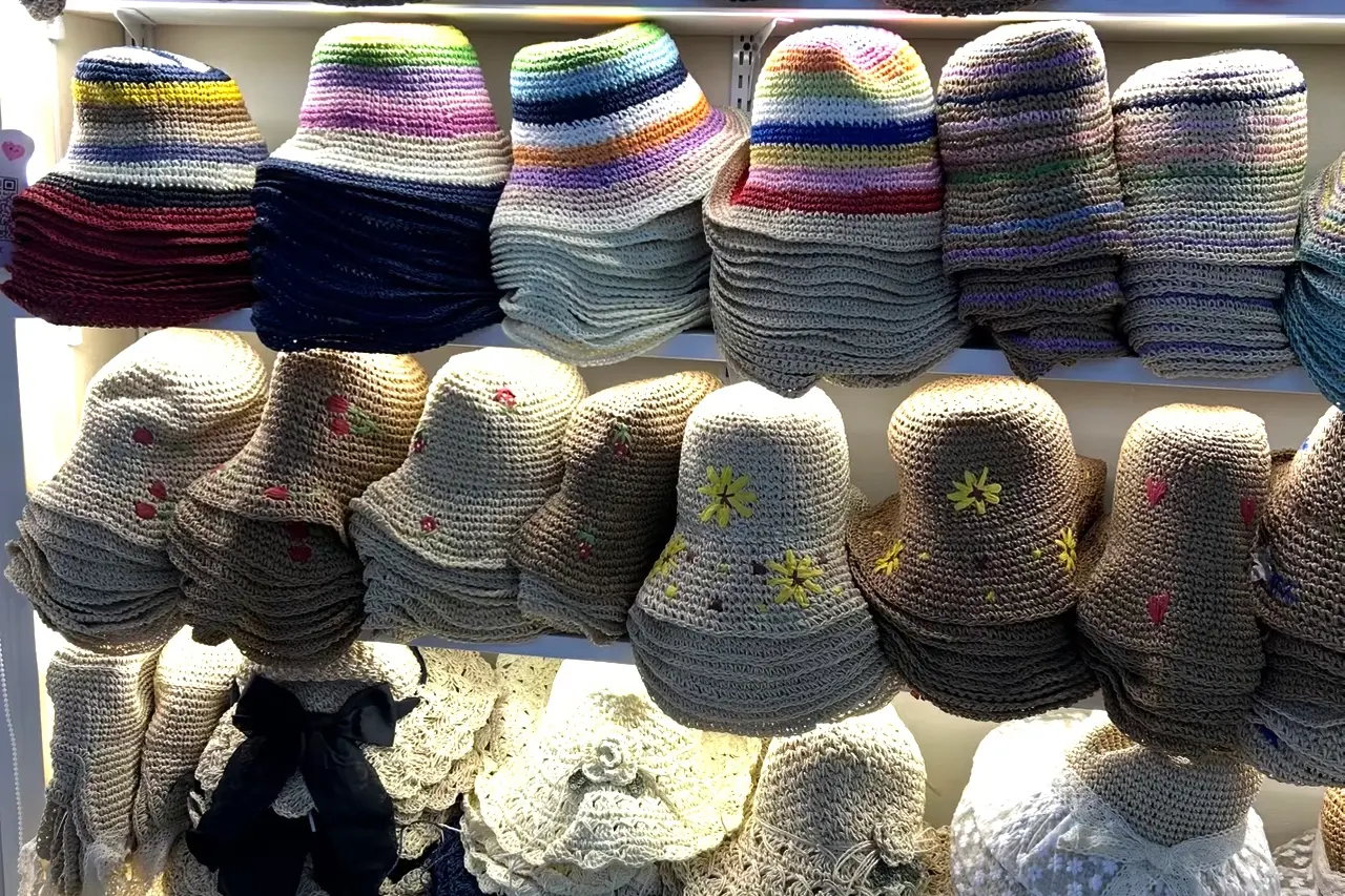 Color-striped and embroidered crochet bucket hats in matching stacks