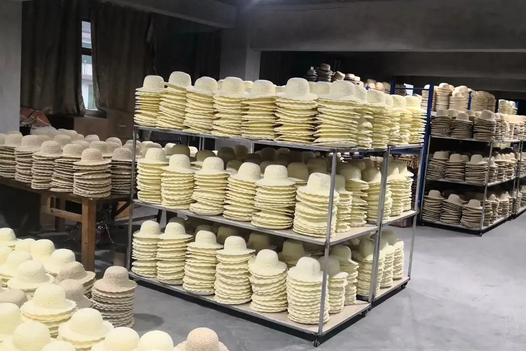 Rows of natural hat bodies filling multiple factory racks