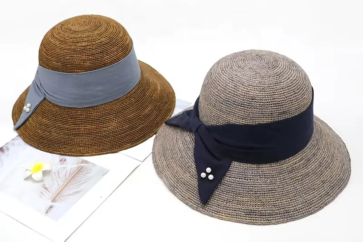 Two coordinated beach straw hats in brown and gray colorways