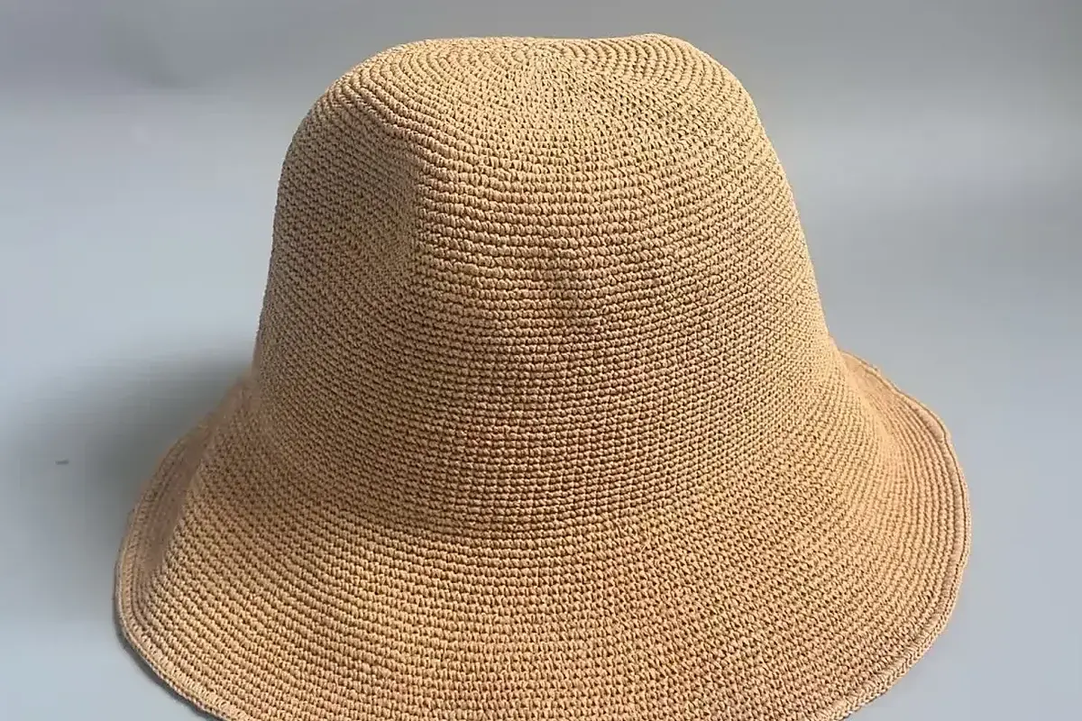 Natural woven beach hat showing its soft crown and brim structure