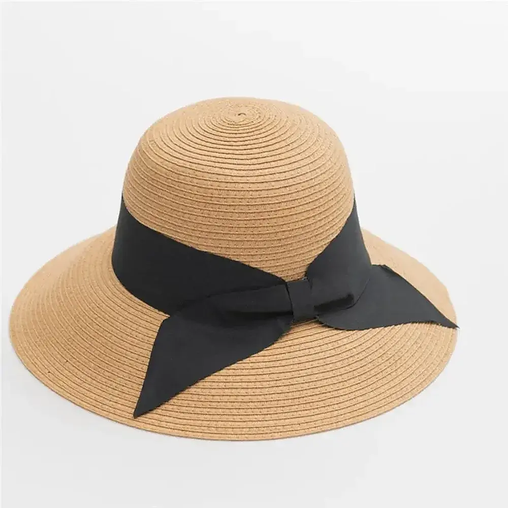 Natural straw bucket beach hat with an oversized black bow