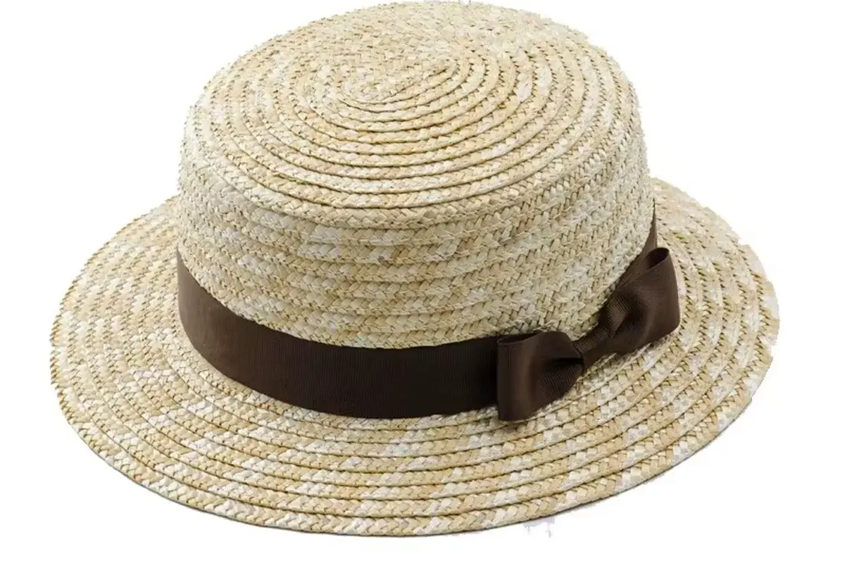 Natural straw boater hat with a level brown ribbon and bow