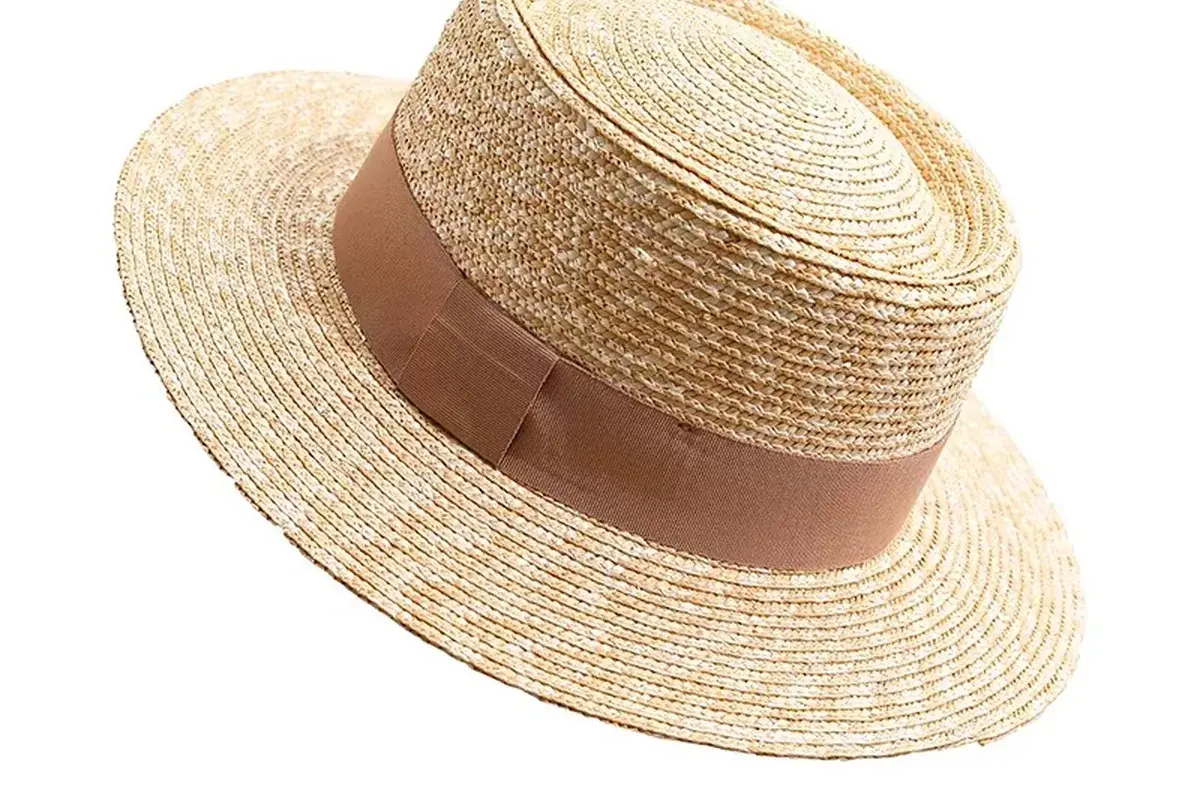 Natural straw boater hat showing a controlled straight brim plane