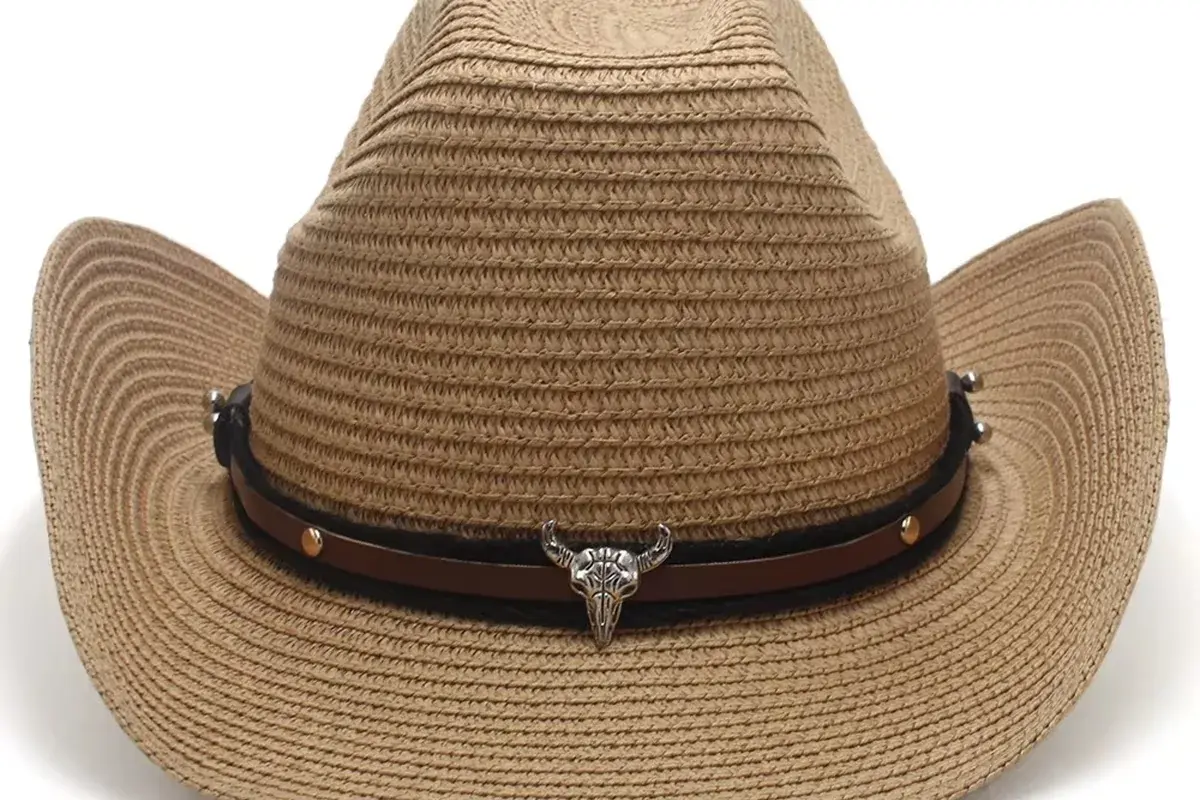 Western straw hat with a leather band and silver steer-head hardware