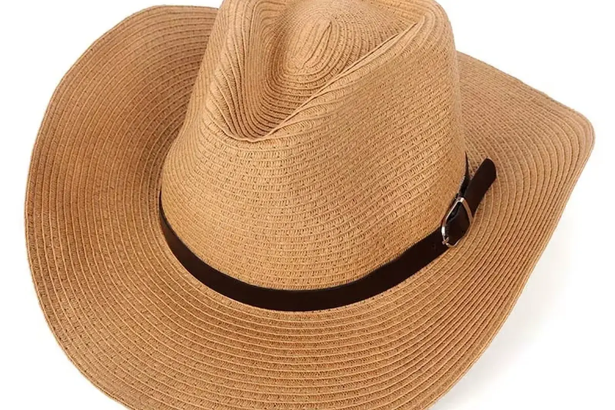 Tan straw cowboy hat showing a pinched crown and balanced Western profile