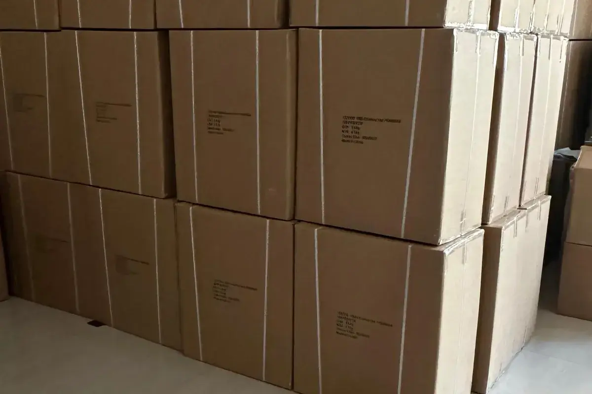 Bulk hat cartons stacked and labeled for shipment