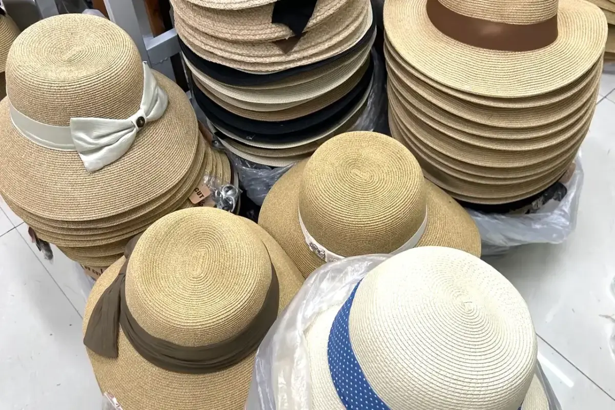 Assorted Panama-style straw hats with bands and bow trims