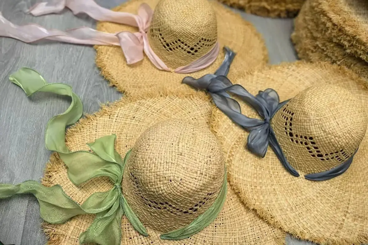 Raffia hats with colorful ribbon trims for resort programs