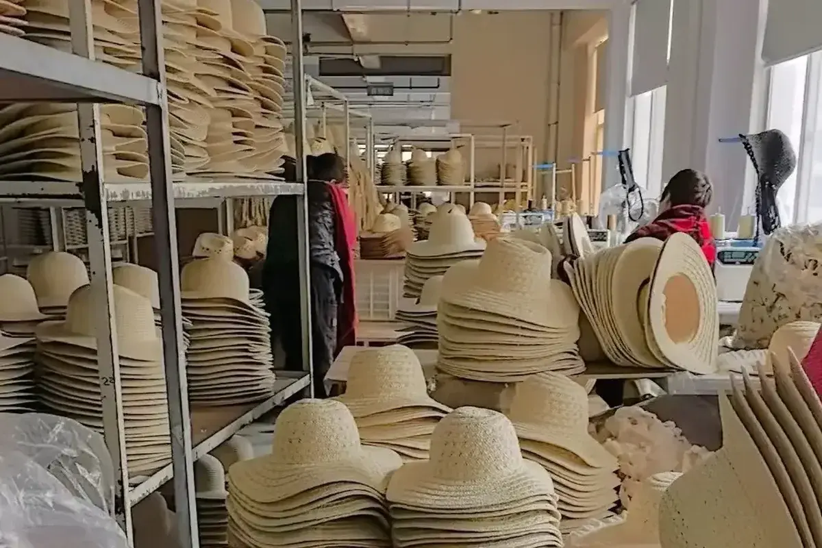Straw bucket hat bodies arranged through the production workshop