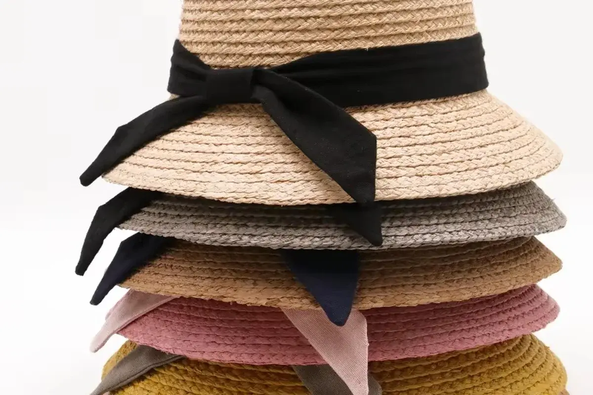 Stack of straw bucket hats showing coordinated shapes and color options