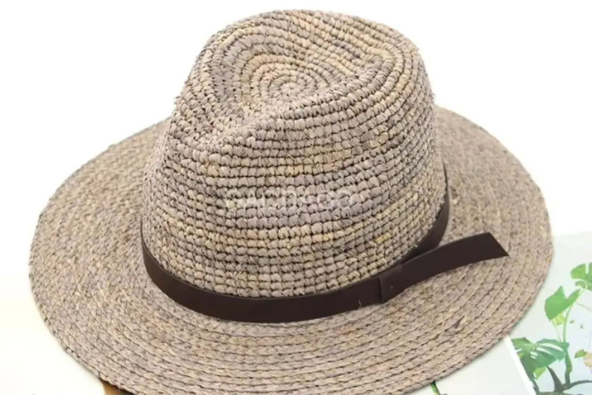 Gray raffia straw fedora showing a controlled wide-brim profile