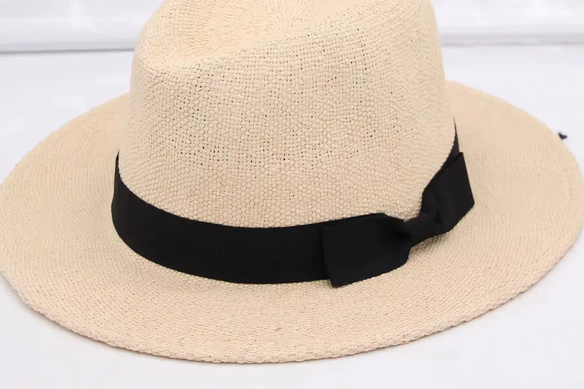 White straw fedora hat showing a defined center dent and front pinch