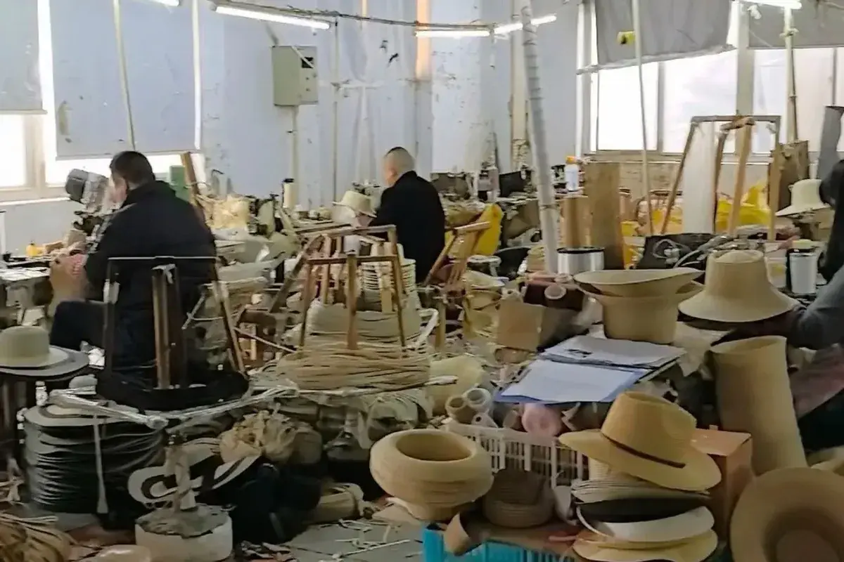 Workers making and shaping straw hats at production workstations