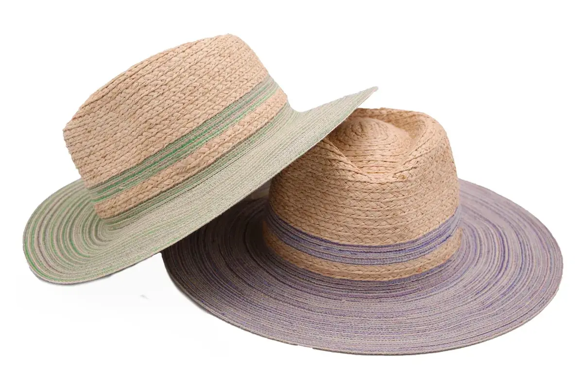 Two straw fedora hats showing different raffia textures and color combinations