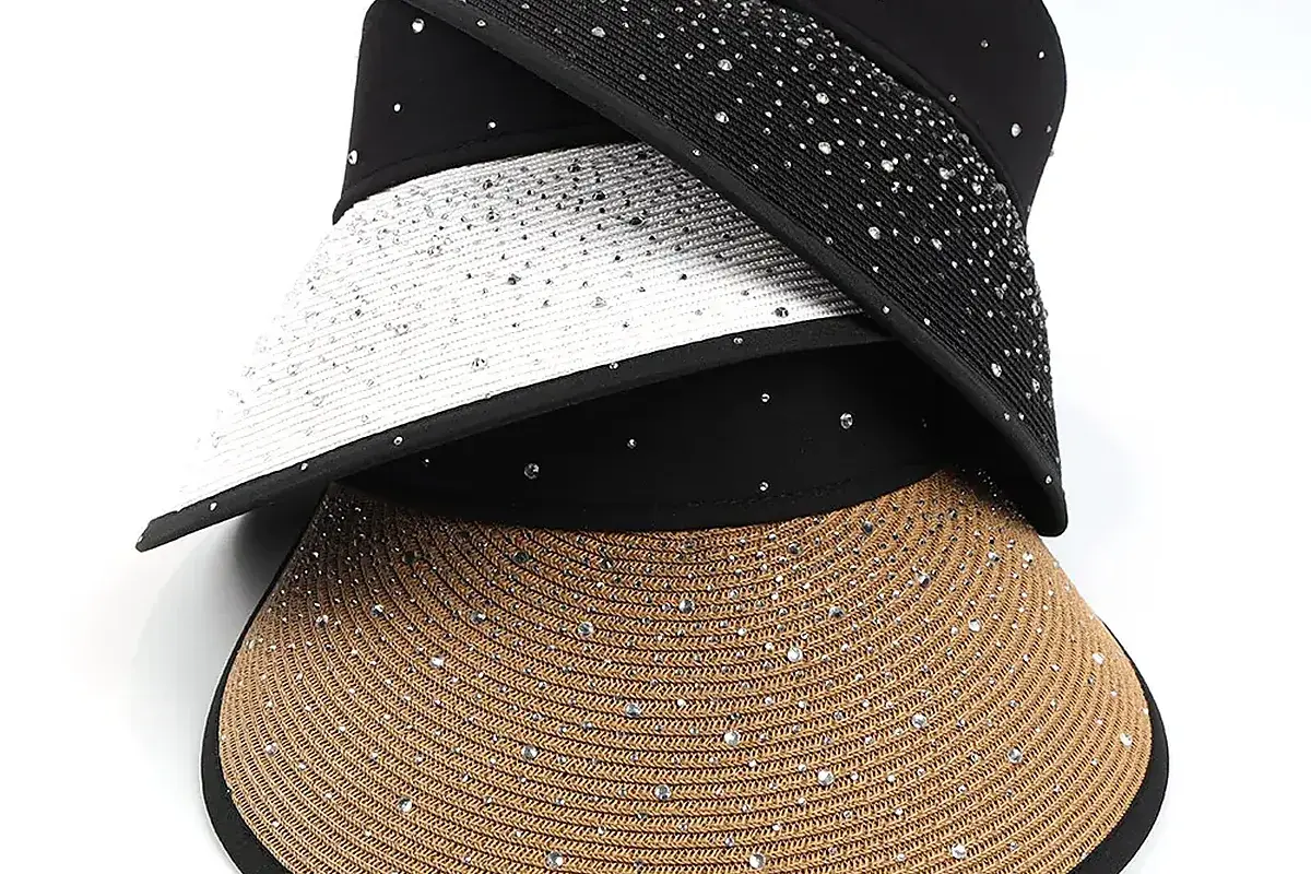 Straw visors with decorative dot patterns across the brim surface