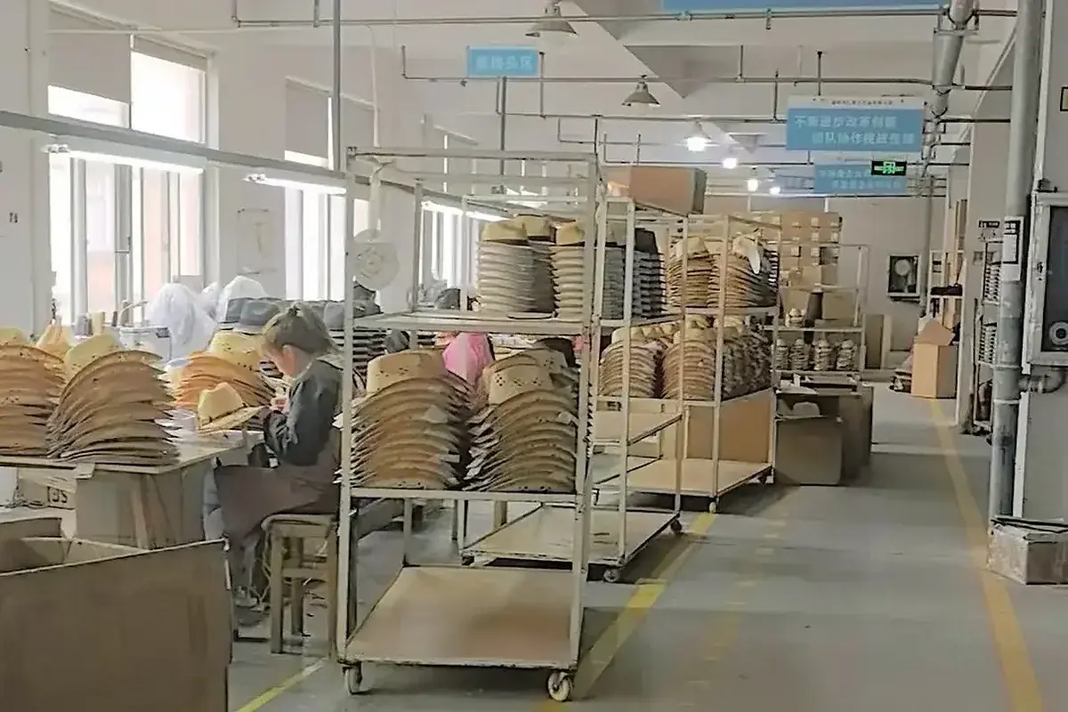 Workers producing straw hats in the LuxoHat workshop