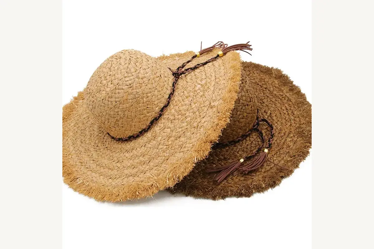 Stack of foldable wide-brim straw hats in natural color variations