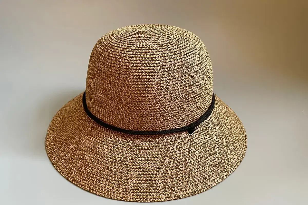 Natural straw hat with a narrow black cord band around the crown