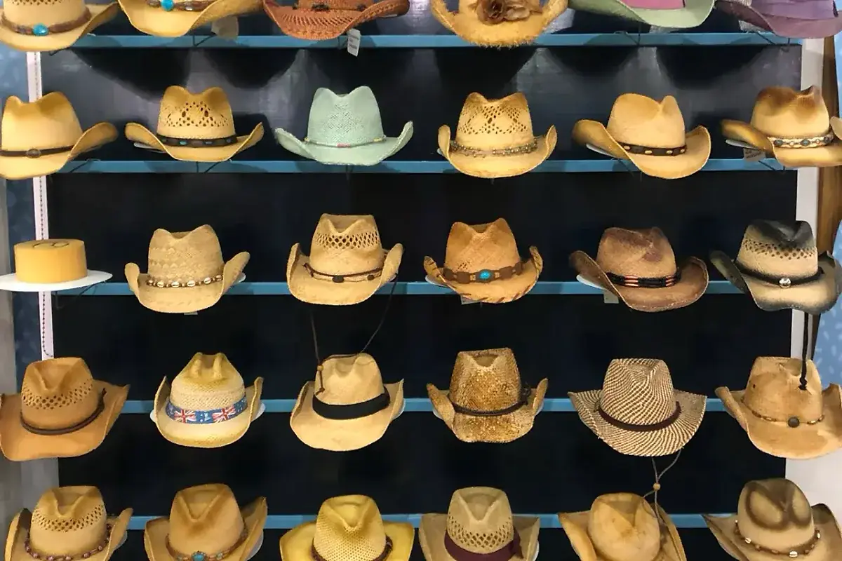 Factory straw hat samples showing ribbon, cord, and leather band options