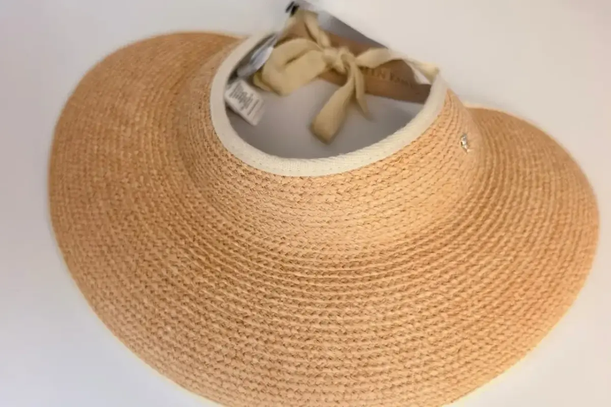 Inside view of a straw visor showing sewn-in product and care labels