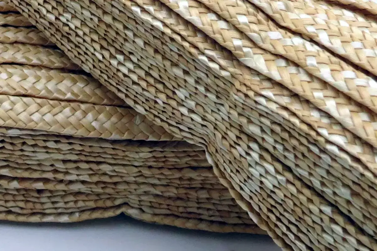 Layered natural wheat straw braids showing traditional woven structure