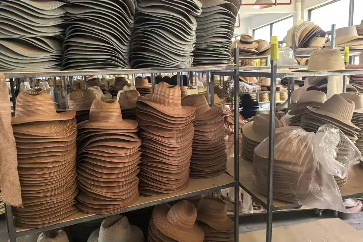 Factory stacks of straw hat bodies showing controlled crown and brim profile changes