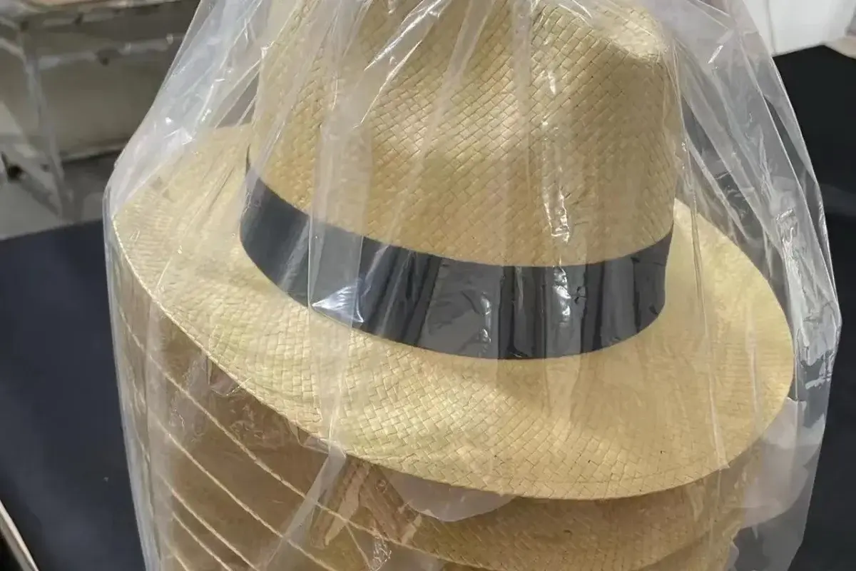Finished straw fedora protected in a clear unit packing bag