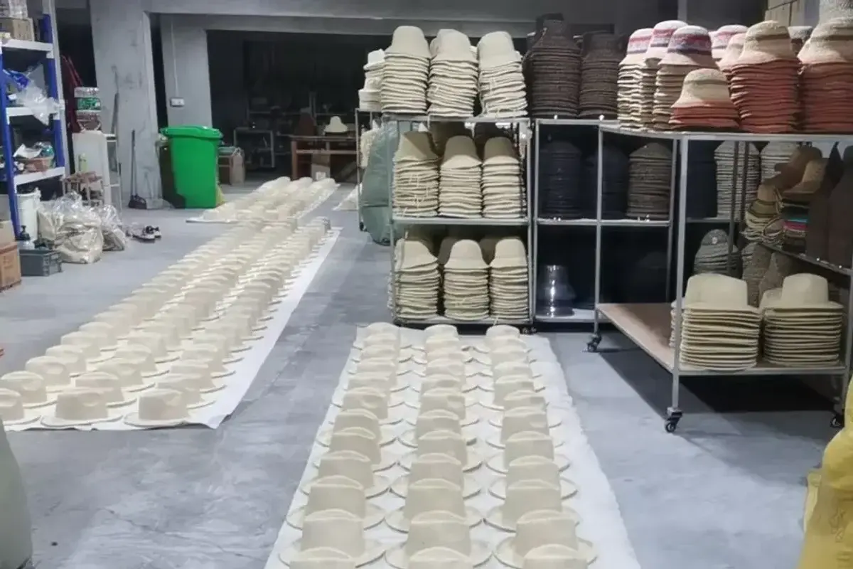 Straw hat bodies arranged in rows for quantity and assortment verification