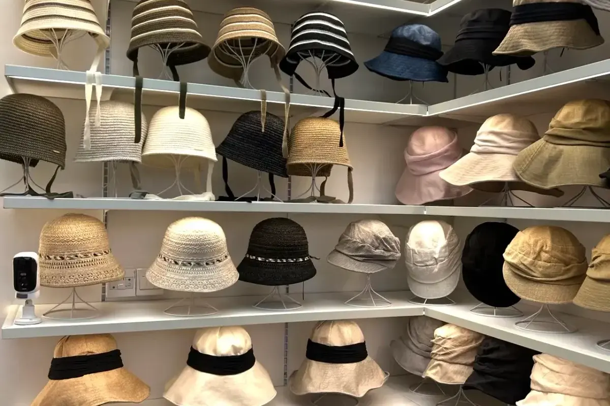 Straw hat samples arranged in the factory sample room for project briefing