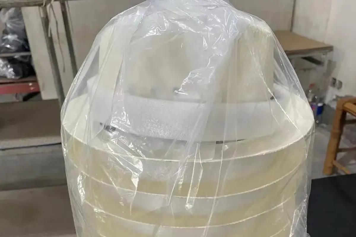 Straw hat stack showing plastic and foam protective packaging layers