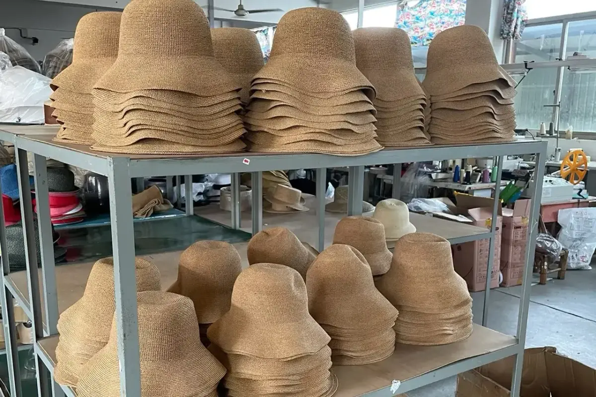 Consistent straw hat bodies grouped at factory production workstations