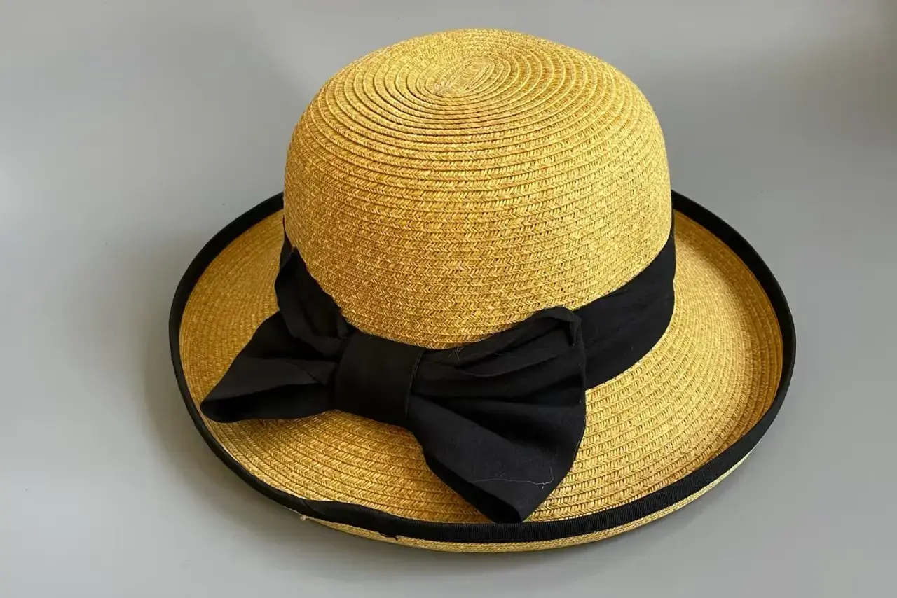 Wide-brim straw hat with black bow for a fashion retail collection