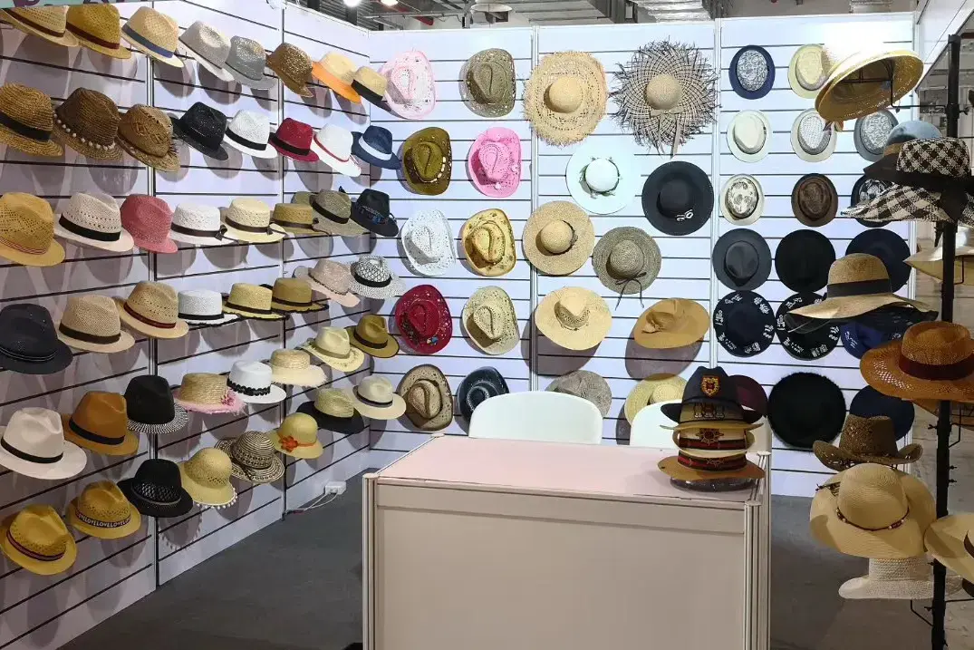 Display wall with straw hats for different wearers and uses